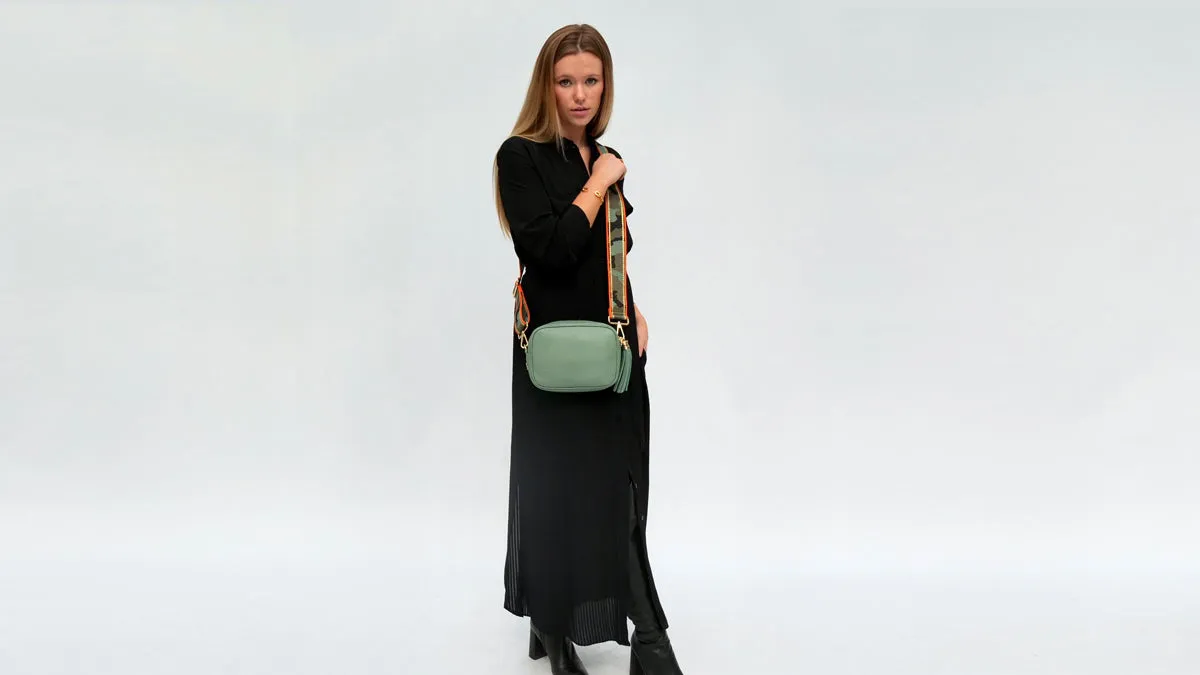 The Tassel Pistachio Leather Crossbody Bag With Orange & Gold Stripe Camo Strap